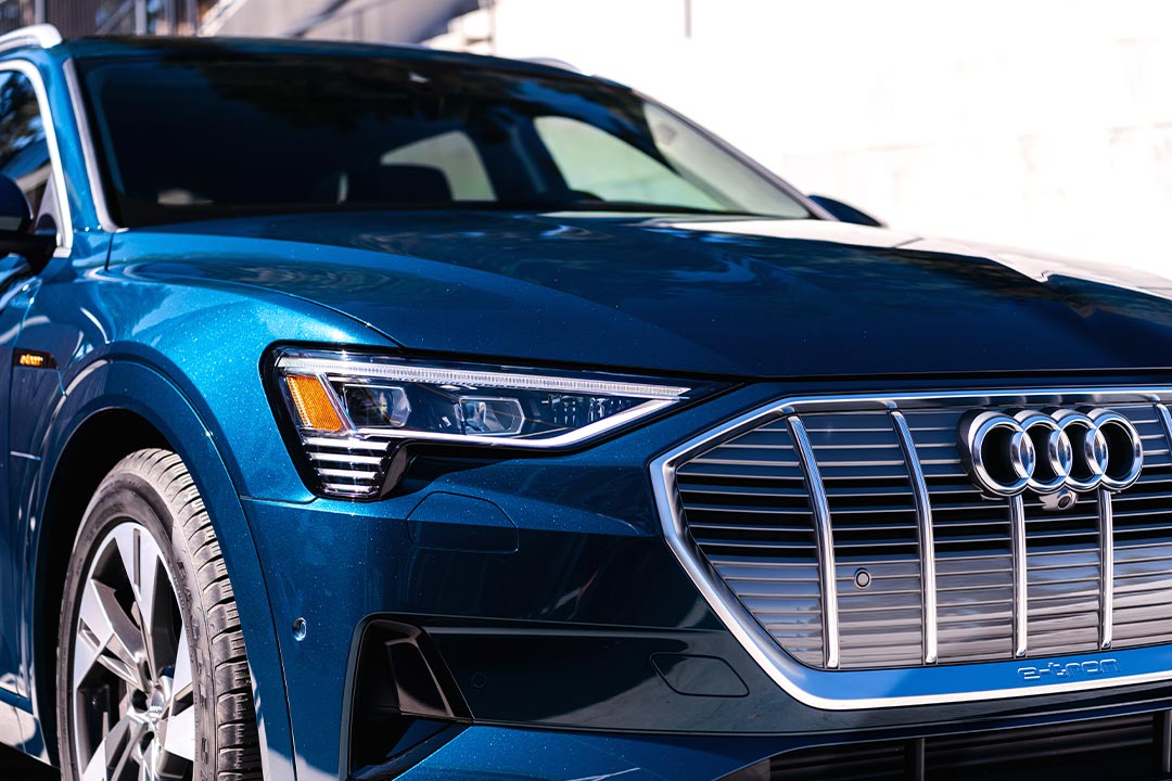e-tron-supporting-img-01 Close up view of the grill and headlight details of an Audi e-Tron electric vehicle